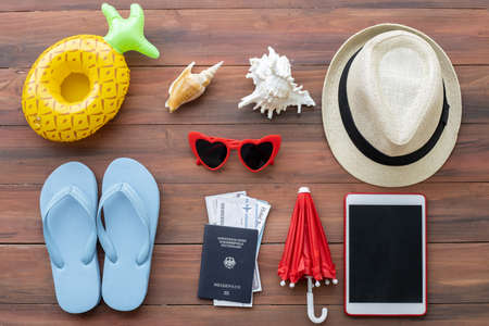 Top view of accessories used for leisure travelers on wood background. Travel accessories and copy...