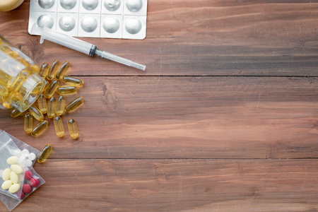 Top view of medicine concept on wood background with copy space. Concept of medicine in medical. Pills, dietary supplements that are stacked together.の写真素材