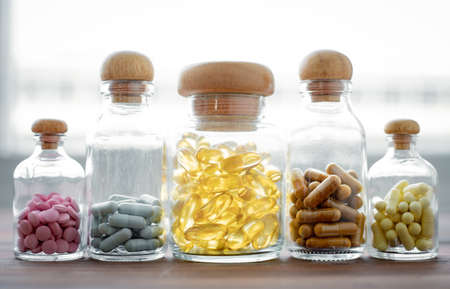Medicine in glass bottle on wood background with copy space. Concept of medicine in medical.の写真素材