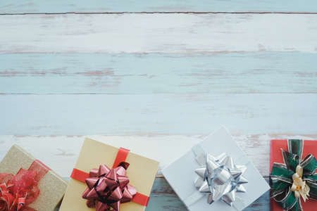 Top view of Christmas composition with gift boxes on wooden background and copy space. Accessories of Christmas and new year concept.の写真素材