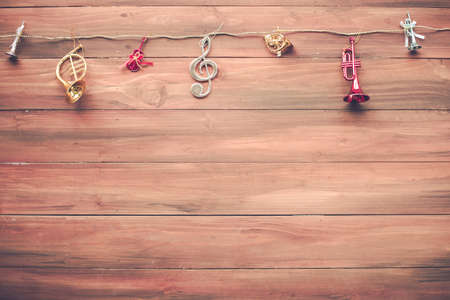 Top view of Christmas composition with music toy on wooden background and copy space. Accessories of...