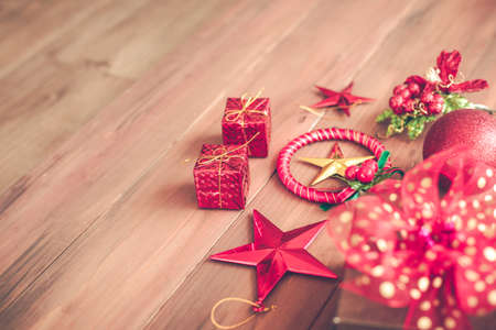 Top view of Christmas composition with gift boxes, ball, star on wooden background and copy space. Accessories of Christmas and new year concept.の写真素材