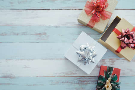Top view of Christmas composition with gift boxes on wooden background and copy space. Accessories...