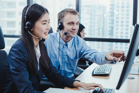 Assistant supervising the call center staff in the office. Manager assistant staffs in a call...