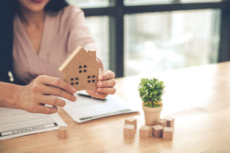 Couple as successful agreement in transaction contract of house. Happy couple in transaction signing contract of house. Concept buy or sell home.の写真素材