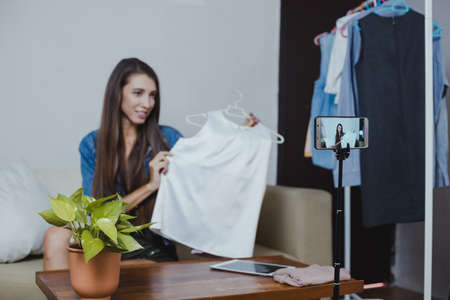 Blogger of caucasian woman with review product and talking camera live recording video on social...