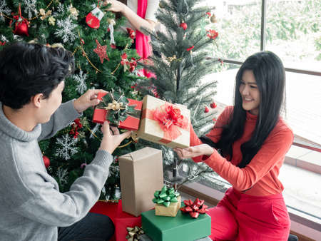 Happy party of group young Asian with gifts at home in celebrating Christmas festival. Thai...