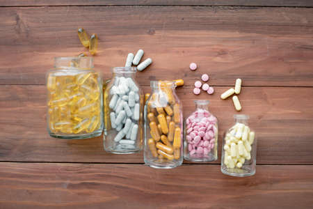 Top view of medicine in glass bottle on wood background with copy space. Concept of medicine in medical.の写真素材