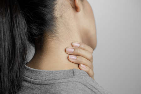Woman with pain in neck. Concept woman suffering from pain in neck.の写真素材