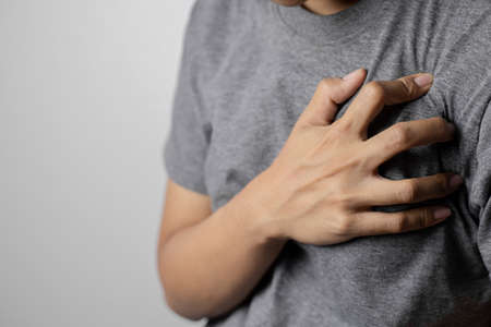 Women with pain at the heart. Young women with heart disease. Women have symptoms of heart attack, congestive heart failure.の写真素材
