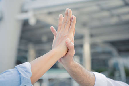 Successful businessman join hands after good deal in the city. Business partnership concept. Join...