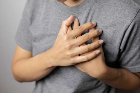 Women with pain at the heart. Young women with heart disease. Women have symptoms of heart attack,...