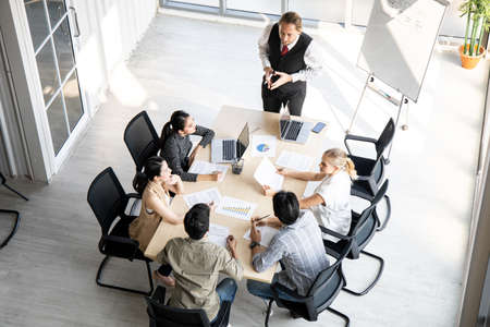 Top view of meetings and consultations of business people in the company's meeting room. Conference...