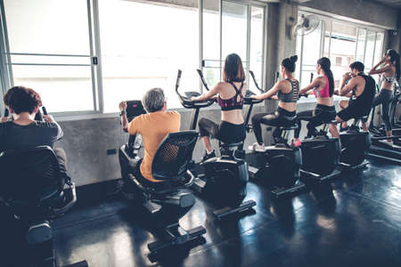 People are exercising with cardio on spinning class by exercise machine in the gym.の写真素材
