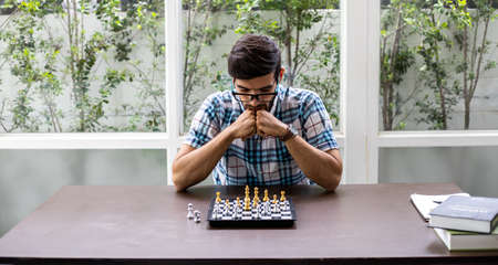 Man developing chess strategy, playing board game. Man thinking chess figure with team strategy and...