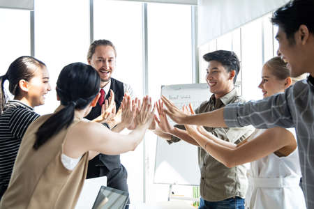 Success of group business people with join hands of teamwork in meeting room. Hands coming together...