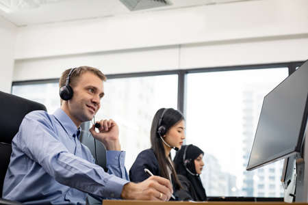 Team call center dedicated to providing efficient customer service with smile.の写真素材