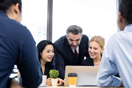 Businessman explaining new business ideas to peers in conference room during meeting at office.の写真素材