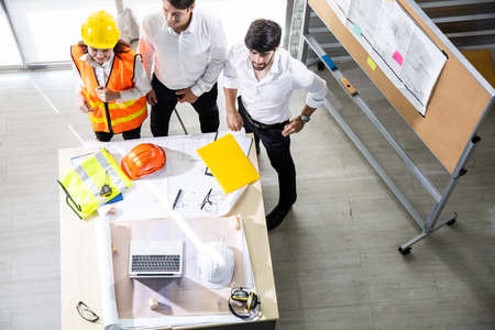 Top view group engineers discussion and planning about project to be made on table.の写真素材