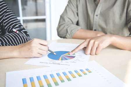 Teamwork with price chart analyzes business people on table at the conference room.