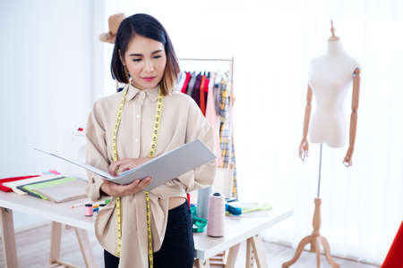 Designer thinking about designing clothes in the studio.の写真素材