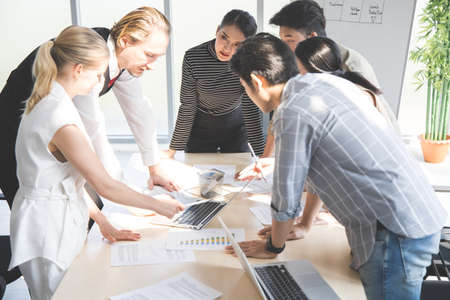 Brainstorming group of business people working on laptop in business teamwork concept.