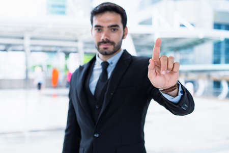 Handsome businessman in a successful suit presents his work convincingly and stylishly.