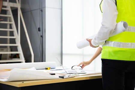 Team of engineers are planning work at meeting room in the factory office.