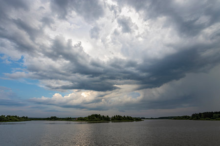 Clouds over the lake on a summer evening before a thunderstorm.の写真素材