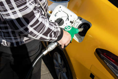 Autumn landscape with early morning fog. Birch trees with bright yellow foliage illuminated by the sun. Trees and hills in the fog. Dawn on a cold autumn morning.の写真素材