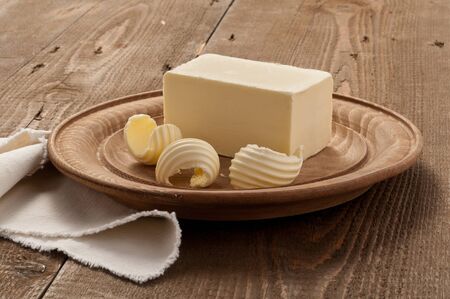 butter on wooden plate - settingの写真素材