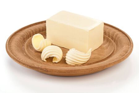 butter on wooden plateの写真素材