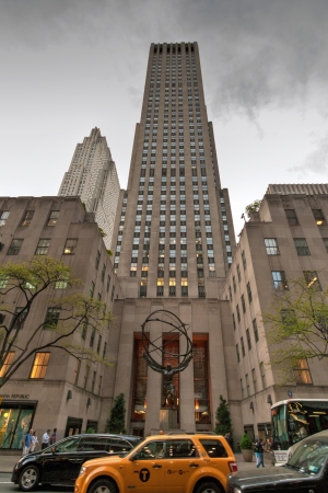 New York, USA - May 7, 2013   Rockefeller Center raises into the sky with Atlas Statue along 5th Avenue in Midtown Manhattan, New York  Some people, cars and taxis passing by on 7th May 2013 のeditorial素材