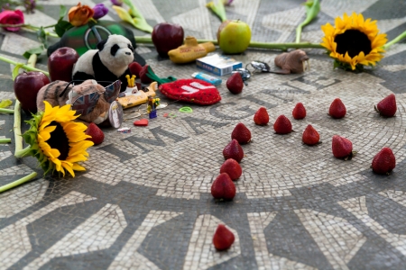 New York, United States - May 6 2013  Strawberry fields Lennon memorial in Central Park with a nice decoration made by fans  Flowers, fruits and objects related to the singer art is displayed in this open sanctuary のeditorial素材