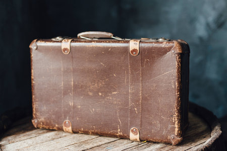 Old brown suitcase on the top of the barrelの写真素材