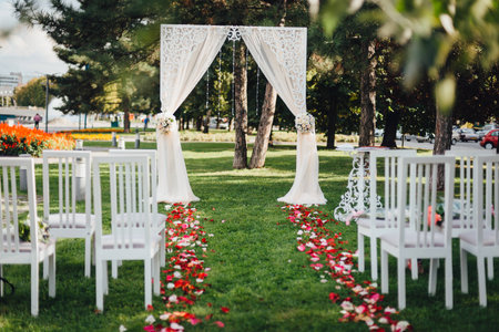 Arch for the wedding ceremony, decorated with cloth and flowersの写真素材
