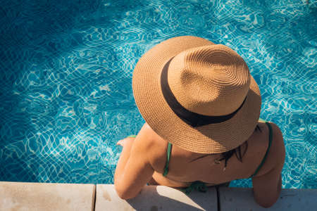 Overhead portrait of young woman relaxing in swimming pool? copy spaceの写真素材