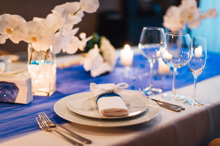 Wedding table decorations with orchids, candle lightの写真素材