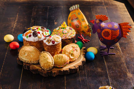 Traditional ukrainian easter Kulich cake and Easter eggs on a wooden desk. Easter chicken figuresの写真素材