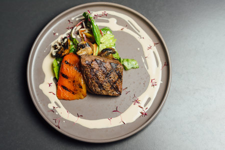 Beef Steak with Vegetables and Mushrooms on a Plateの写真素材
