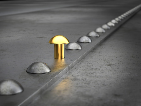 Row of rivets on the metal grunge background. One golden rivet in the row. Leadership concept.