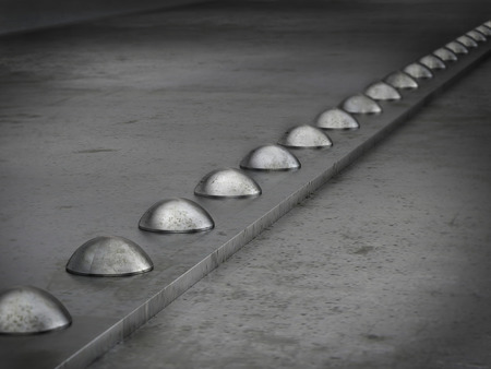 Row of rivets on the metal grunge backgroundの写真素材