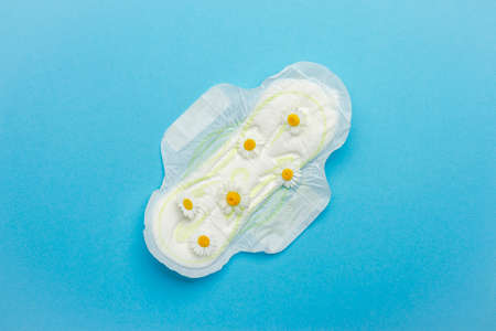 Feminine hygiene Chamomile flowers composition on blue background.の写真素材