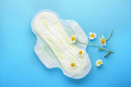 Feminine hygiene Chamomile flowers composition on blue background.の写真素材