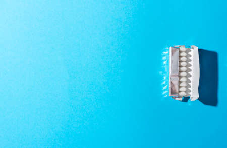 Open package of gum on yellow background.