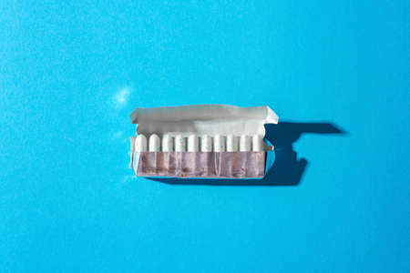 Open package of gum on yellow background.