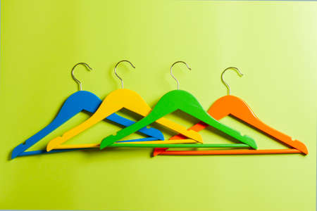 Multicolored hangers on a green background.