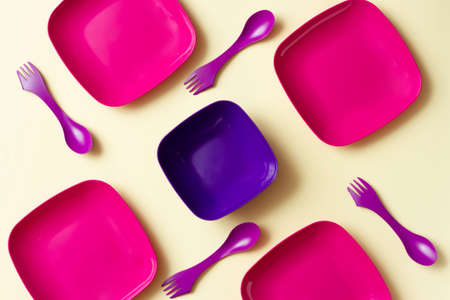 Plastic dishes on a cream background.の写真素材