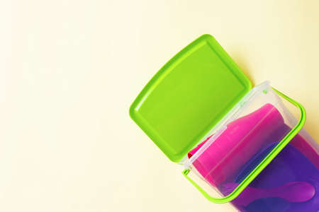 Plastic dishes on a cream background.