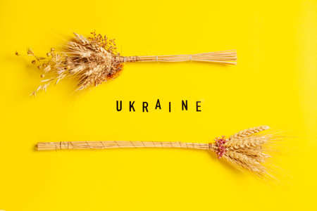 Composition with ears of wheat and the word Ukraine in honor of the independence of Ukraine on a yellow background.の写真素材